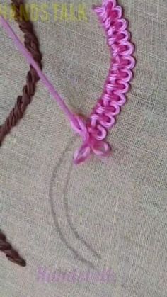 a close up of a pink flower on a piece of cloth