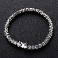 This glamorous 5mm tennis bracelet is crafted in lustrous sterling silver. This alluring bracelet features round with Crystals, and shimmering, and is beautifully arranged in a tennis style. Our tennis bracelets is made with the greatest attention to quality and minutest details and enhanced with a high polish finish, Its stunning sparkle design with precision craftsmanship gives you a beautiful bracelet to wear and admire without being too loose This beautiful bracelet is the perfect gift for y Moissanite Bracelet, Hiphop Jewelry, Sparkle Design, Tennis Style, Diamond Chain, Round Moissanite, Hip Hop Jewelry, Tennis Bracelet Diamond, Cuban Link