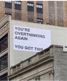 a sign on the side of a building that says you're overthiking again you got this