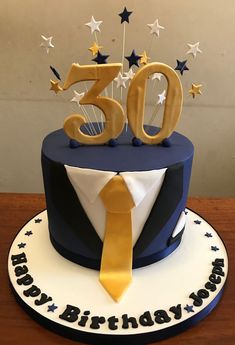 a blue and white birthday cake with the number 50 on it's top tier