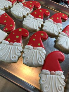 decorated cookies in the shape of santa's hats