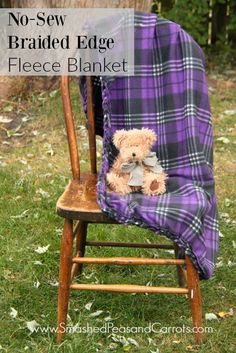 a teddy bear sitting on top of a wooden chair covered in a blanket with the words braided edge fleece blanket