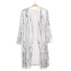 Step into the spotlight with this dazzling silver sequin kimono - the ultimate statement piece! Crafted with shimmering sequins and sheer white fabric, this kimono is designed to turn heads and steal the show. With its eye-catching sequin embellishments, this kimono adds a touch of sparkle and glamour to any ensemble. Whether you're attending a party, concert, festival or a special event this open front sequin duster is sure to make you feel like a star. The flowing silhouette and lightweight fabric make this sequin kimono both comfortable and stylish. Pair it with your favorite leather skinnies for a sophisticated look or layer it over jeans and a band shirt for a more casual-chic vibe. Make a bold fashion statement and sparkle like never before in this silver sequin kimono.  Details * Si Summer Sequined Long Sleeve Outerwear, Sequined Long Sleeve Summer Outerwear, White Fall Party Cardigan, Spring Party Kimono With Open Front, White Sequined Long Sleeve Outerwear, Spring Party Open Front Kimono, White Sequined Outerwear For Party, Elegant Sequined Cardigan For Spring, Elegant Spring Sequin Cardigan