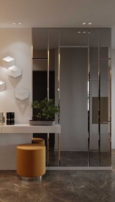 a modern bathroom with marble flooring and white walls, along with a plant in the corner