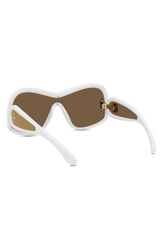 Looping golden logos adorn the temples of sleek Italian-made sunglasses shaped in a mask-inspired silhouette. 144mm lens width; 20mm bridge width; 145mm temple length 100% UV protection Injected plastic Made in Italy Brown Mirror, Golden Logo, Uv Protection, Sleek, Nordstrom, Mask, Sunglasses