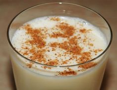 a glass filled with milk and topped with cinnamon