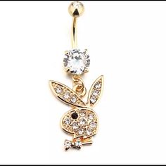 a gold plated belly ring with an animal and crystal stones on the bottom,