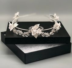 This wedding tiara offers the perfect touch of regal appeal in a clean and soft silhouette. Eternally elegant, charming vine details weave along a fine metal headband and feature slender stems of clear crystals, white flowers and silver leaves.  A delicate versatile piece that works well with a range of hairstyles from loose up styles to long untamed curls. DETAILS  > Designed and handcrafted in the UK Worldwide shipping > Handcrafted from tarnish resistant jewellery wire, handmade white clay fl Dainty Tiara, Bridal Pearl Headband, Tiara Flower, Floral Headpiece Wedding, Crystals White, Floral Tiara, Jewellery Wire, Pearl Bridal Headband, Flower Tiara