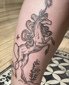 a black and white photo of a unicorn on the leg