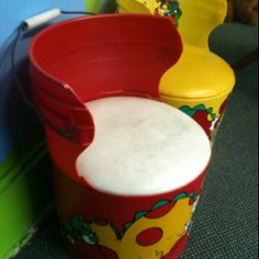 two children's toy buckets sitting next to each other