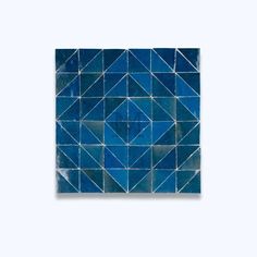 a square tile with blue triangles on it