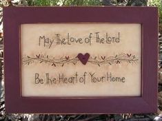 a framed sign that says, may the love of the lord be the heart of your home