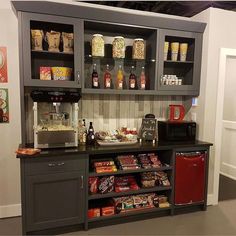 a coffee bar with lots of food and drinks on it's shelves in a room