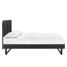 a bed with white sheets and black headboard on it's side, in front of a white background