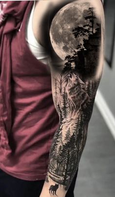 a man's arm with a wolf on it and trees in the background, under a full moon