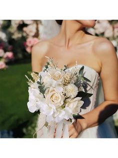 a woman holding a bouquet of flowers in her hand