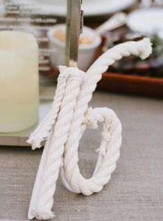 a white rope is tied to a metal stand