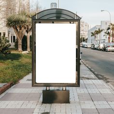 a bus stop with a white sign on it