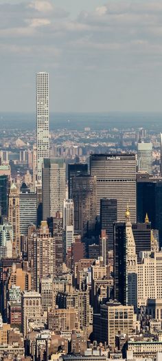 an aerial view of the city skyline with skyscrapers and other tall buildings in the foreground