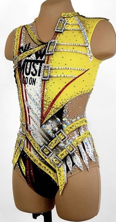 a female mannequin wearing a yellow top and black shorts with sequins