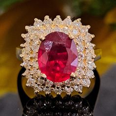 This Ruby is authentic as they are grown in a lab environment. 3.75 Carat Lab-created Ruby & Natural Diamonds 14k Solid Yellow Gold Ring Ring Material: 14k Solid Gold Approximate Weight: 5.8 Grams Band Width about 2.0 mm Gemstone: Lab-created Ruby Gemstone Color: Red Gemstone Clarity: Moderately Included Gemstone Shape: Oval Gemstone Dimensions are about: 9.70x7.90 mm Gemstone Carat Weight about: 2.80 Carat Gemstone Quantity: 1 Diamonds: Natural Round Shaped Diamonds Color: G Diamonds Clarity: S Gia Certified Oval Ruby Ring, Oval Ruby Ring With Diamond, Exquisite Oval Ruby Ring Gia Certified, Dazzling Oval Ruby Ring With Diamonds, Oval Ruby Ring With Vvs Clarity Diamond, Luxury Oval Diamond Ring With Lab-created Ruby, Gia Certified Oval Diamond Ring Fine Jewelry, Gia Certified Oval Diamond Ring, Gia Certified Oval Cluster Ring