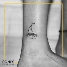 a small sailboat tattoo on the ankle