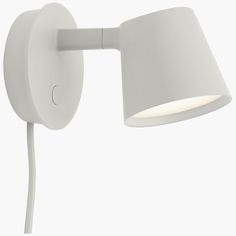 a white wall lamp with a light on it