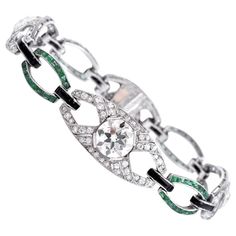 This antique Art Deco link bracelet of immaculate design and craftsmanship is constructed in solid platinum. It is composed of gracefully convex diamond and emerald links adjoined by delicate links set with an onyx top. It is set with three large round diamonds. 1st diamond is an old round European approx. 3.05 carats I, color, VS1 clarity, 2nd diamond is a round old European, approx. 1.73 cts I color, VS1 clarity and 3rd diamond is a round old European cut approx. 3rd diamond is round approx. w Platinum Bracelet, Retro Bracelet, Bracelet Tennis, Diamond Necklace Designs, Platinum Diamond Engagement Rings, Gold Link Bracelet, Art Deco Bracelet, Emerald Bracelet, Antique Bracelets