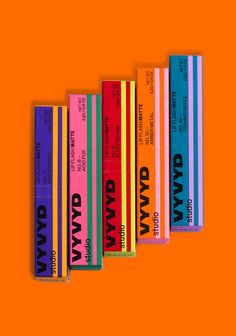 four colorful books are lined up on an orange background with the words david david written in black