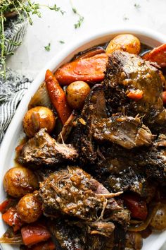 a white plate topped with meat and veggies