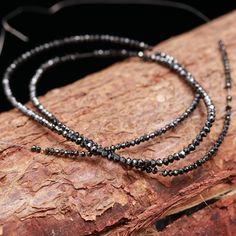 AAA+ Quality Natural Black Diamond Faceted Rondelle Beads Size : 2-2.4 mm Length : 38 cm Shape : Rondelle Faceted/Plain: Faceted Raw diamonds, are also called rough diamonds. Bright light and sparkle of an uncut diamond is something of a charming beauty. Untouched by professional hands Black Rondelle Beaded Necklaces, Black Diamond Beads, Black Rondelle Gemstone Beaded Necklace, Black Beaded Rondelle Necklace, Black Necklace With Oval Spacer Beads, Elegant Black Tiny Beads, Gold Rondelle Beads With Faceted Details, Faceted Black Spinel Necklace, Black Gemstone Round Beads