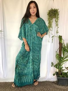 Hand Stamped Batik Dyed Long Kaftan Dress in teal green color hues. This Long Kaftan Maxi Dress made of soft, delicate and lightweight rayon with 2 hidden pockets on each side. Its so convenience to wear a dress with 2 big pockets to store your phone, keys and any other personal belongings without Bohemian V-neck Dress With Natural Dye, Spring V-neck Kaftan With Batik Print, V-neck Batik Print Festival Dress, Bohemian V-neck Maxi Dress With Batik Print, Festival Batik Print V-neck Maxi Dress, Green V-neck Free Size Kaftan, Festival V-neck Maxi Dress With Batik Print, V-neck Batik Print Dress For Festival, Bohemian Rayon Dress With Kimono Sleeves