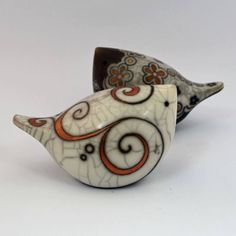 two ceramic birds sitting next to each other