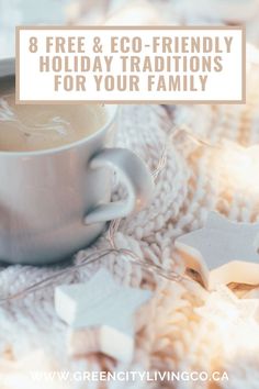 a cup of coffee sitting on top of a white blanket next to star shaped cookies