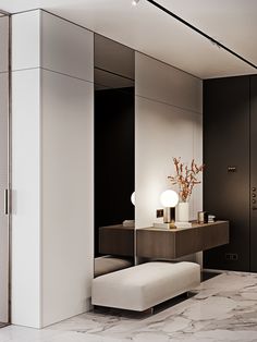 a bathroom with marble flooring and walls, along with a white bench in front of the mirror