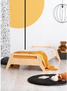 a child's bedroom with yellow and white decor, including a bed frame in the shape of a circle