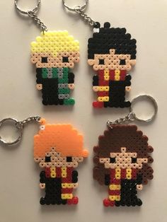 four keychains made out of perler beads, each with an image of the same character