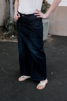 Need a full length denim skirt? This is a beautiful option. A timeless dark wash with plenty of stretch allowing it to fit perfectly. Also comes with plenty of pockets, 5 in fact. Amazing pocket detail and belt loops are all part of the deal. Paired here with the Brenda White top. dark wash light distress pockets maxi Model is 5'4",bust 35", waist 27", hips 38" wearing size small Cheap Medium Wash Relaxed Denim Skirt, Cheap Workwear Denim Skirt With Pockets, Affordable Denim Skirt With Pockets, Classic Cheap Denim Skirt, Cheap Relaxed Fit Medium Wash Denim Skirt, Casual Cotton Denim Skirt, Cheap Casual Dark Wash Denim Skirt, Medium Wash Relaxed Denim Skirt, Affordable High Rise Dark Wash Skirt