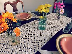 a table topped with vases filled with colorful flowers