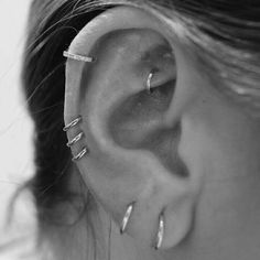 a woman with three piercings on her ear