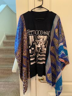 I made super cute poncho from a a vintage kantha quilt and a Fleetwood Mac tshirt. The sides are open. I can make a small wide sleeve and sew the sides up about 3 inches. Please just let me know. no worries Short Sleeve Patchwork Tops For Loungewear, Oversized Bohemian Cotton T-shirt, Bohemian Oversized Cotton T-shirt, Bohemian Style T-shirt For Fall Festival, Bohemian Blue Printed T-shirt, Bohemian Fall Festival T-shirt, Bohemian Patterned Top With Patchwork, Bohemian Patchwork Patterned Top, Bohemian Patterned Tops With Patchwork