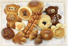 there are many different types of breads on the table together, including teddy bears and other pastries