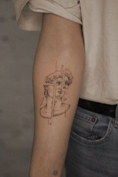 a woman's arm with a line work tattoo on the left side of her right arm