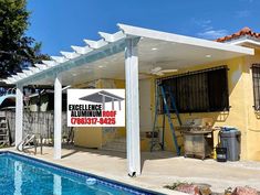 a house with a pool in front of it and a sign that says excellence roofing