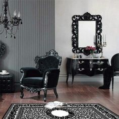 a black and white living room with chandelier, chair, table and mirror