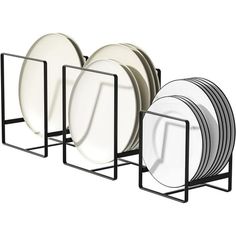 a stack of white plates sitting next to each other on a black stand with metal holders