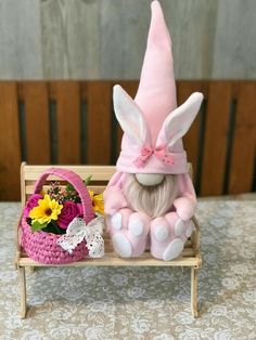 a stuffed animal sitting on top of a wooden bench next to a basket with flowers