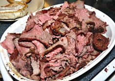 a plate full of meat sitting on top of a table