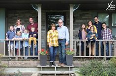 a group of people standing on the front porch of a house