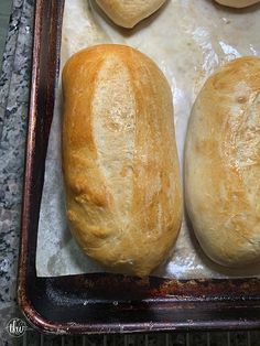 three loaves of bread sitting on top of a baking pan